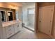 Modern bathroom with marble shower, double vanity and tile flooring at 223 Willow St, Canton, GA 30114