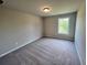 Neutral bedroom features a carpeted floor and a bright window to the outside at 223 Willow St, Canton, GA 30114