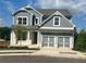Charming two-story home with gray exterior, white trim and a two-car garage at 223 Willow St, Canton, GA 30114