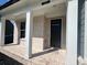 Charming brick front porch with white columns and black door at 223 Willow St, Canton, GA 30114
