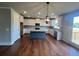 Open concept kitchen with island, stainless steel appliances, and white cabinets at 223 Willow St, Canton, GA 30114