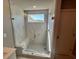 Walk-in marble shower with a bench and a window at 223 Willow St, Canton, GA 30114