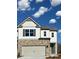 Charming two-story home with stone accents, gray shutters, a two-car garage, and a welcoming front door at 2474 Bayberry St # 33, Acworth, GA 30101