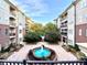 Beautiful courtyard featuring a large fountain, benches, and mature landscaping between buildings at 3635 E Paces Ne Cir # 1405, Atlanta, GA 30326