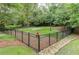 Enclosed dog park with mature trees, a water hydrant, and plenty of room for furry friends to roam at 3635 E Paces Ne Cir # 1405, Atlanta, GA 30326