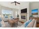 Cozy living room with fireplace, large windows, and comfortable seating area at 3635 E Paces Ne Cir # 1405, Atlanta, GA 30326