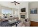Cozy living room with fireplace, large windows, and comfortable seating area at 3635 E Paces Ne Cir # 1405, Atlanta, GA 30326