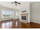 Sunlit living room with a cozy fireplace, hardwood floors, and a modern ceiling fan at 3635 E Paces Ne Cir # 1405, Atlanta, GA 30326