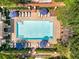 Aerial view of a community pool with lounge chairs and blue umbrellas surrounded by greenery at 3635 E Paces Ne Cir # 1405, Atlanta, GA 30326