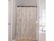 Bright bathroom featuring a tub and shower combination with decorative curtain and neutral paint at 4381 Prather Son Dr, Loganville, GA 30052