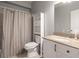 Neutral bathroom featuring a shower with curtain, toilet, vanity with light countertop and mirror at 4381 Prather Son Dr, Loganville, GA 30052