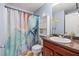 Neutral bathroom featuring granite countertops, decorative shower curtain and yellow flower accents at 4381 Prather Son Dr, Loganville, GA 30052