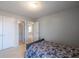 Bedroom with light-grey walls, carpeted floor, and adjacent closet and entry doors at 4381 Prather Son Dr, Loganville, GA 30052