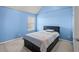 Cozy bedroom with a large bed, blue painted walls and natural light from a window with blinds at 4381 Prather Son Dr, Loganville, GA 30052