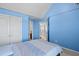 Bright bedroom with high ceilings, fresh blue paint, and a comfortable bed and closet at 4381 Prather Son Dr, Loganville, GA 30052