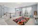Open bonus room features an attractive overhead light fixture, natural light and decor throughout at 4381 Prather Son Dr, Loganville, GA 30052