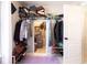 Walk-in closet with shelving on three walls, lots of extra storage space and a purple rug at 4381 Prather Son Dr, Loganville, GA 30052
