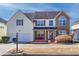 Charming two-story home with a combination of vinyl siding and brick facade with front porch at 4381 Prather Son Dr, Loganville, GA 30052