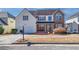 Two-story home with stone accents, dormer windows, covered porch, and two-car garage at 4381 Prather Son Dr, Loganville, GA 30052