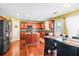Bright eat-in kitchen boasts stainless steel appliances, central island, wood floors, and dining area at 4381 Prather Son Dr, Loganville, GA 30052
