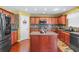 Well-equipped kitchen featuring granite countertops, central island, stainless steel appliances, and hardwood floors at 4381 Prather Son Dr, Loganville, GA 30052