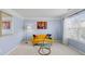 Cozy sitting room featuring a colorful accent wall, unique artwork, and comfortable seating by a sunny window at 4381 Prather Son Dr, Loganville, GA 30052