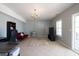 Bright living room with tile floor, large windows and sliding glass door to outside patio at 4381 Prather Son Dr, Loganville, GA 30052