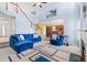 Spacious living area with open floorplan, comfortable blue seating, fireplace, and easy access to kitchen and foyer at 4381 Prather Son Dr, Loganville, GA 30052