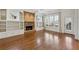 Bright and open living room featuring a brick fireplace, built-ins, hardwood floors and natural light at 460 High Pointe Trl, Roswell, GA 30076