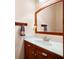 Bathroom featuring a wood trimmed mirror, vanity with sink and chrome faucet, and towel hooks at 5301 Hill Nw Rd, Acworth, GA 30101