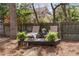 Inviting backyard with a small raised deck featuring lounge chairs, tiki torches and decorative plants at 1207 Thornwell Ne Dr, Brookhaven, GA 30319
