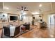Basement living area with comfortable seating, built-in cabinets, a wet bar, and hardwood floors at 1207 Thornwell Ne Dr, Brookhaven, GA 30319
