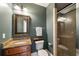 Well-lit bathroom with a granite countertop vanity, framed mirror, and a glass-enclosed shower at 1207 Thornwell Ne Dr, Brookhaven, GA 30319
