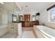 Spa-like bathroom featuring a soaking tub, walk-in shower, and dual vanities at 1207 Thornwell Ne Dr, Brookhaven, GA 30319
