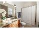 Bathroom featuring a granite countertop vanity, pendant lighting, and a shower with curtain at 1207 Thornwell Ne Dr, Brookhaven, GA 30319