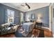 Cozy bedroom with blue walls, hardwood floors, and ample natural light from two windows, creating a serene space at 1207 Thornwell Ne Dr, Brookhaven, GA 30319