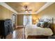 Cozy bedroom featuring a decorative ceiling, hardwood floors, and a large red metal bed frame at 1207 Thornwell Ne Dr, Brookhaven, GA 30319