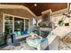 Inviting covered patio with brick fireplace, comfortable seating, and wood-paneled ceiling at 1207 Thornwell Ne Dr, Brookhaven, GA 30319