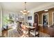 Elegant dining room with a large window, classic chandelier, and access to the foyer at 1207 Thornwell Ne Dr, Brookhaven, GA 30319
