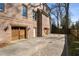 Long driveway leading to garage of the brick home with a basketball court in the back at 1207 Thornwell Ne Dr, Brookhaven, GA 30319