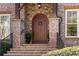 Charming brick home featuring a beautiful arched front door with stone and wooden accents at 1207 Thornwell Ne Dr, Brookhaven, GA 30319