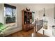 Well-lit hallway featuring hardwood floors, decorative cabinet, and natural light from a large window at 1207 Thornwell Ne Dr, Brookhaven, GA 30319