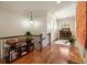 Bright hallway features hardwood floors, a display table, and an arched window at the end of the hall at 1207 Thornwell Ne Dr, Brookhaven, GA 30319