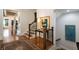 Elegant staircase and hallway featuring hardwood floors and decorative artwork at 1207 Thornwell Ne Dr, Brookhaven, GA 30319