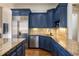 Beautiful kitchen featuring granite counters, stainless appliances, and stylish blue cabinetry at 1207 Thornwell Ne Dr, Brookhaven, GA 30319