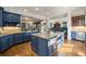 Gourmet kitchen with blue cabinetry, large island, and an open layout that flows into the living area at 1207 Thornwell Ne Dr, Brookhaven, GA 30319