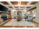 Spacious living room with hardwood floors, coffered ceilings, stone fireplace, and large windows at 1207 Thornwell Ne Dr, Brookhaven, GA 30319