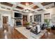 Inviting living room with a stone fireplace, coffered ceilings, and hardwood flooring at 1207 Thornwell Ne Dr, Brookhaven, GA 30319