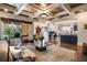 Open-concept living room featuring hardwood floors, coffered ceilings, and a large window view at 1207 Thornwell Ne Dr, Brookhaven, GA 30319