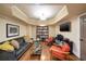 Inviting living room with a comfortable sofa, hardwood floors, built-in bookcase, and a large TV at 1207 Thornwell Ne Dr, Brookhaven, GA 30319